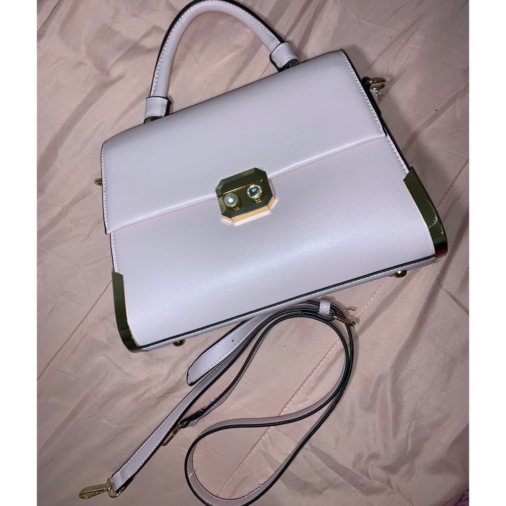 Baby pink with gold detailing purse.